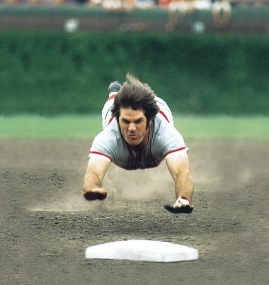 Photo:  Pete Rose dives into third base during a 1975 game between the Cubs and Reds